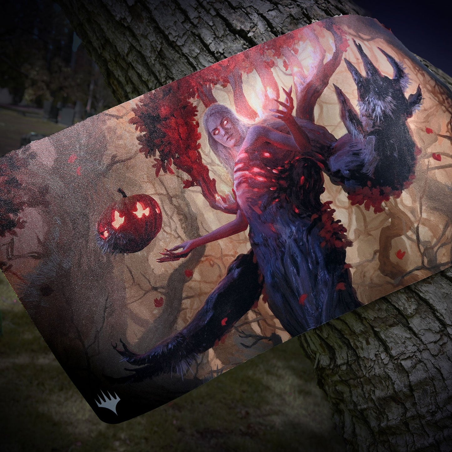 A Magic: The Gathering playmat featuring Wrenn and Seven from Innistrad: Midnight Hunt, with a pumpkin and a dark, monstrous figure against a forest background. Brand: Magic: The Gathering, Item: Innistrad: Midnight Hunt Wrenn and Seven Standard Gaming Playmat.