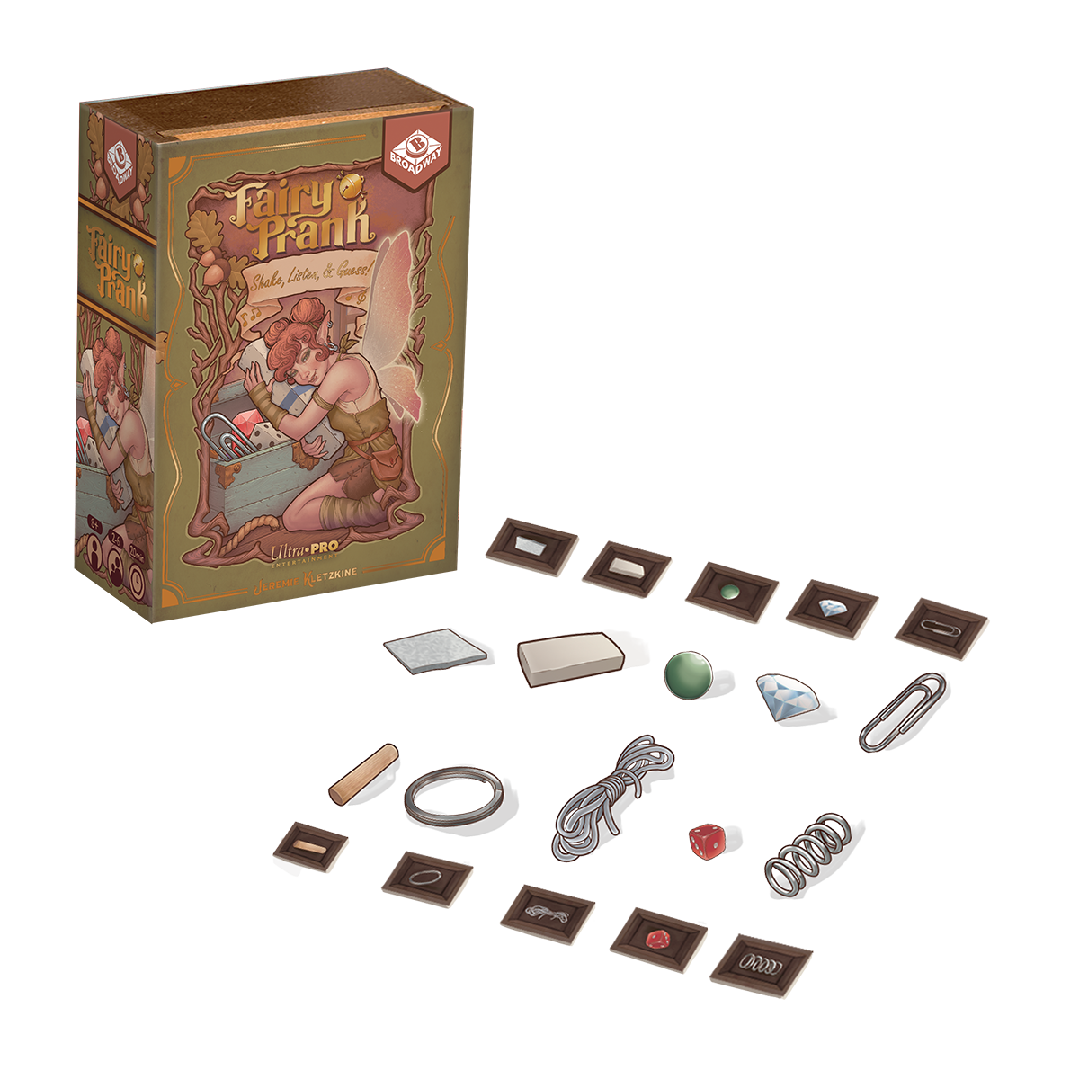 A cardboard game box for Fairy Prank, with various game components scattered around it.
