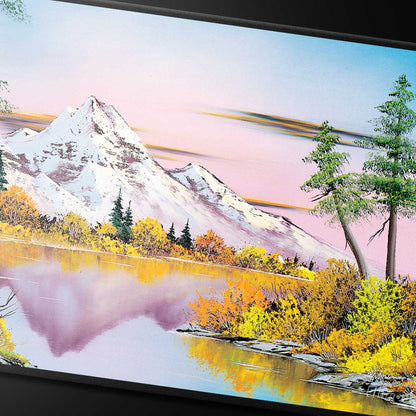 A Bob Ross Mighty Mountain Lake Black Stitched Playmat featuring a serene landscape with snow-capped mountains, a calm lake, and vibrant autumn trees.
