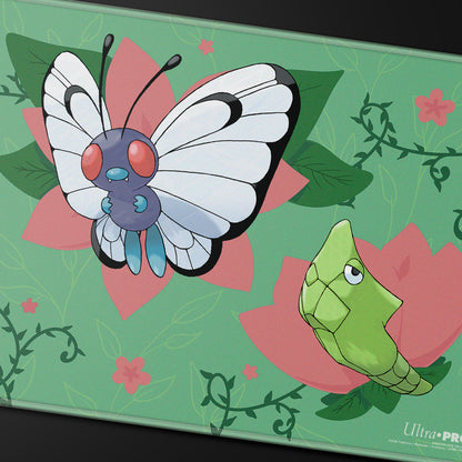 A green playmat featuring Butterfree and Metapod from the Pokémon Trading Card Game. Brand: Ultra PRO, Item: Caterpie Evolutions Stitched Playmat.