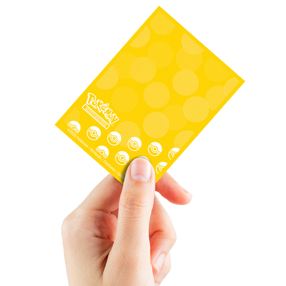 A yellow Pokemon Trading Card Game deck protector sleeves with polka dots and pokeballs. Brand: Pokemon, Item: Energy - Lightning Type 65ct DECK PROTECTOR® Sleeves for Pokémon.