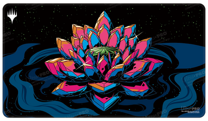 A black playmat featuring a stylized, crystalline Jeweled Lotus in vibrant pink, blue, and orange, set against a starry night sky and dark blue water. Brand: Ultra PRO, Item: Commander Masters Jeweled Lotus HOLOFOIL® Standard Gaming Playmat.