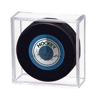 A clear acrylic display holder for a hockey puck. Brand: Ultra PRO, Item: Hockey Puck Souvenir Display Holder.