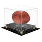 A clear acrylic basketball display case with a black base and gold accents, featuring an autographed basketball. Brand: Ultra PRO, Item: Football Riser Premium Display Case.