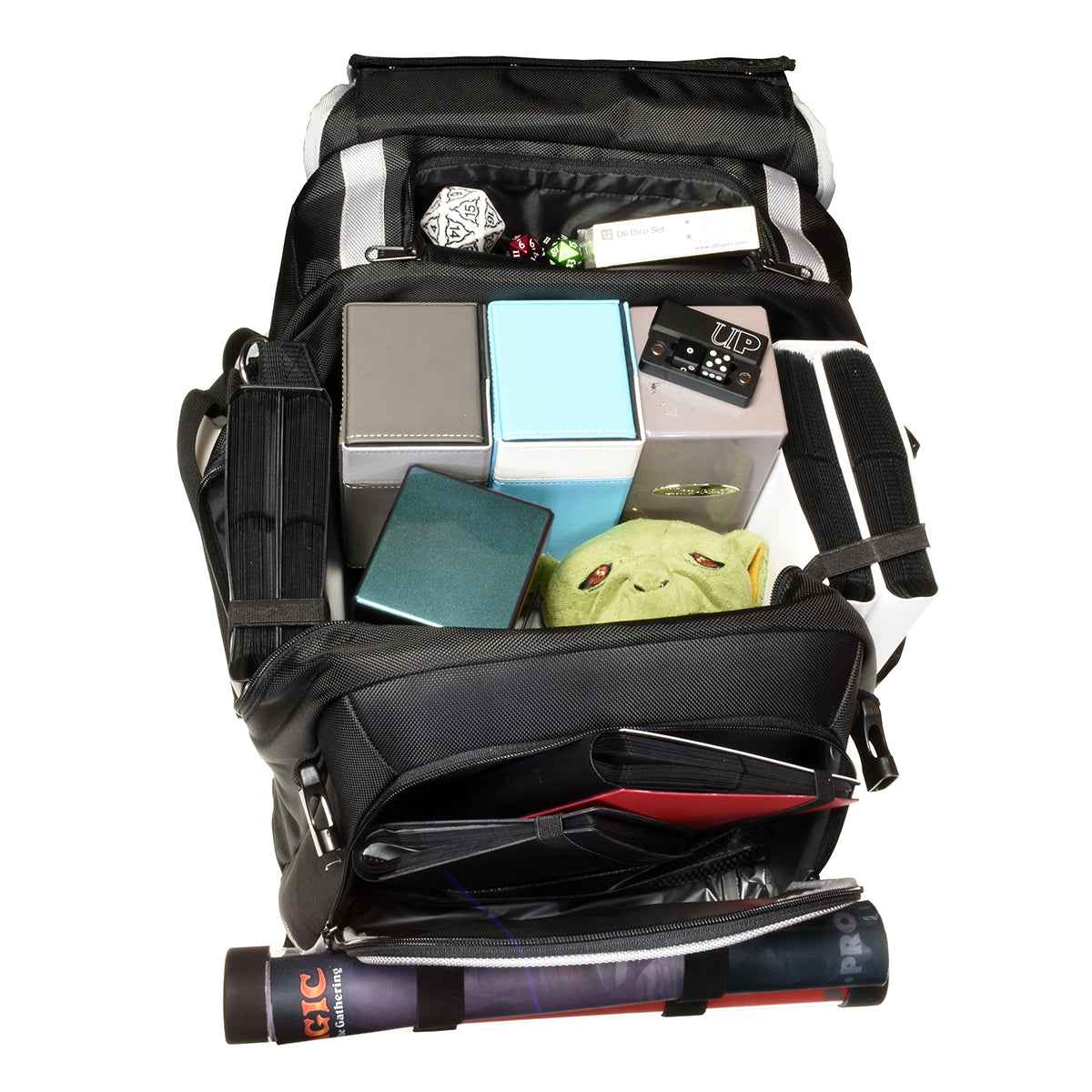 A black backpack with silver trim, filled with various gaming accessories including deck boxes, dice, and a plush toy.