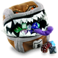 A plush Dungeons & Dragons Mimic Gamer Pouch from Ultra PRO, designed to look like a treasure chest with sharp teeth and a purple tongue, holding various dice.
