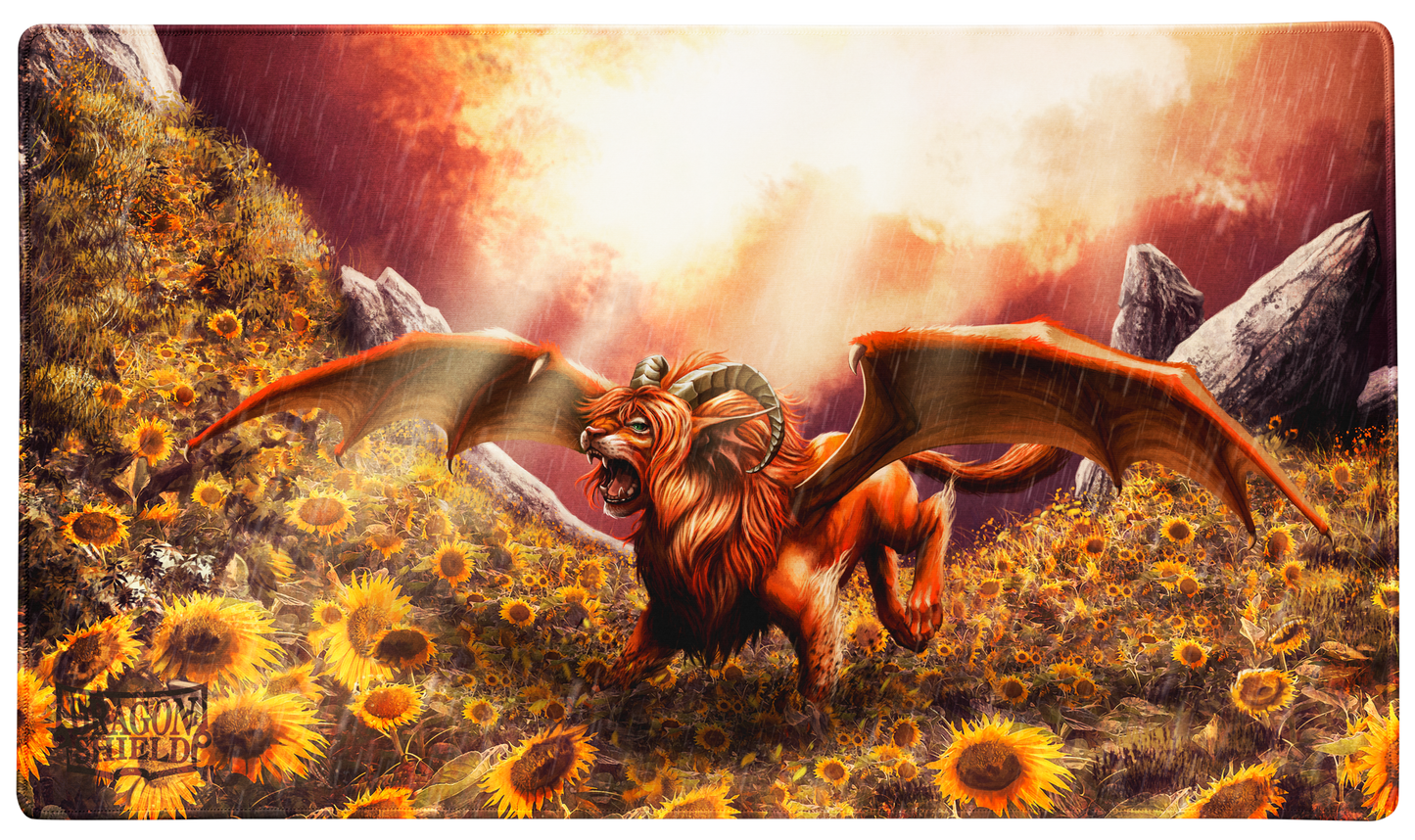 A fantasy art TCG Playmat featuring a winged lion-like creature with horns amidst a field of sunflowers during a rainstorm. Brand: Dragon Shield, Item: Dyrkottr, Last of His Kind - TCG Playmat.