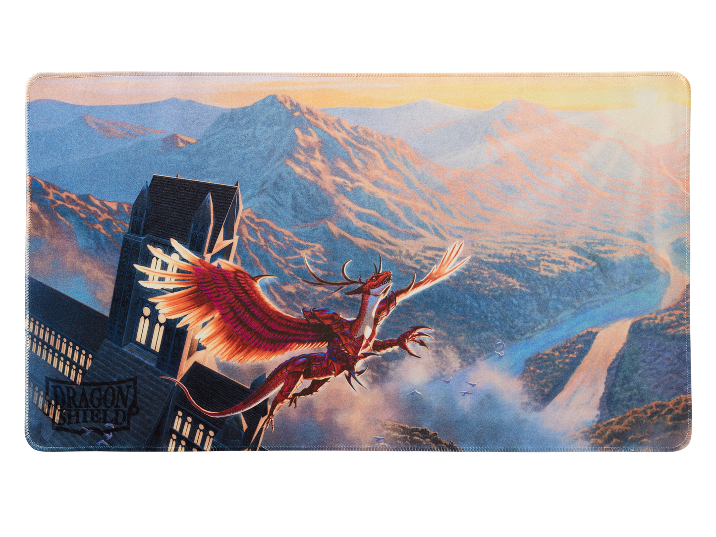 A red dragon flying near a gothic building with mountains in the background. Brand: Dragon Shield (Dev), Item: Logi - TCG Playmat.