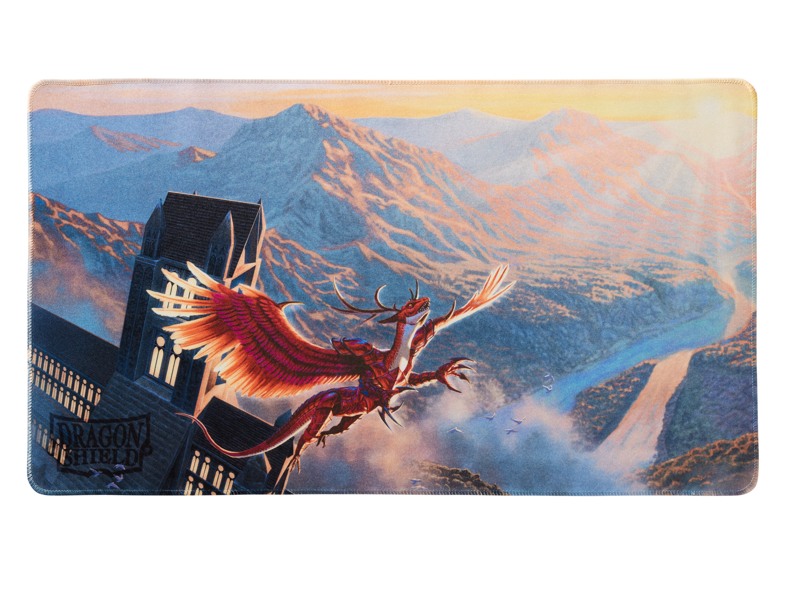 A red dragon flying near a gothic building with mountains in the background. Brand: Dragon Shield (Dev), Item: Logi - TCG Playmat.