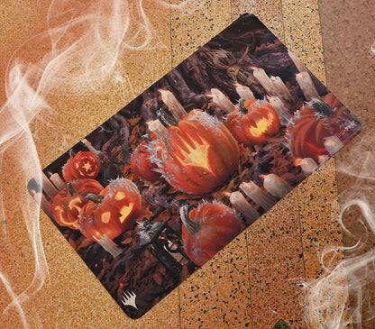A stylized Magic: The Gathering playmat featuring carved pumpkins and candles with a spooky Innistrad theme. Brand: Ultra-Pro, Item: Innistrad: Midnight Hunt Stylized Planeswalker Symbol Standard Gaming Playmat