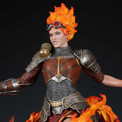 A detailed statue of Chandra Nalaar from Magic: The Gathering, featuring fiery hair and armor.