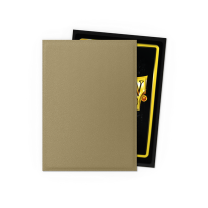 A tan matte Japanese size Dragon Shield card sleeve with a black and gold card partially visible. Brand: Dragon Shield (Dev), Item: Truth - Matte Dual Sleeves